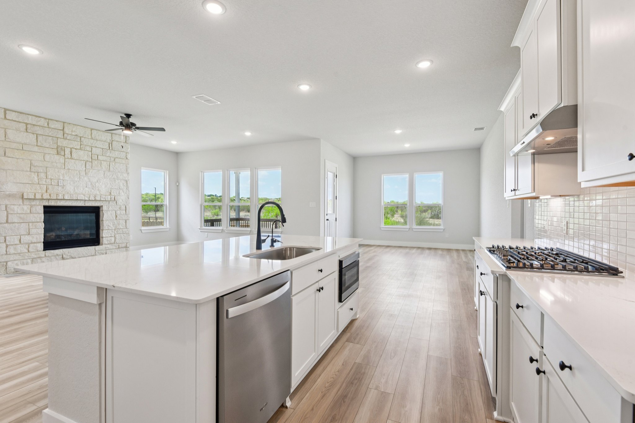 A kitchen with white cabinets.