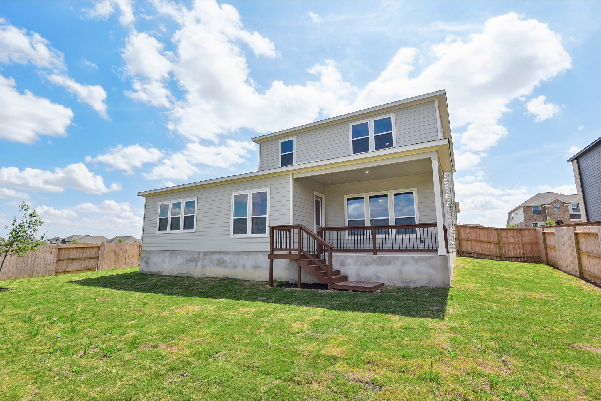 A house with a fence and grass.