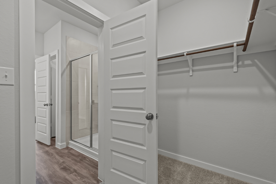 A white closet with a glass door.