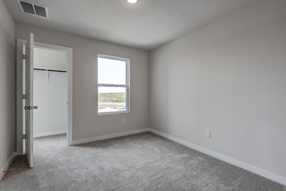 A room with a window and a door.