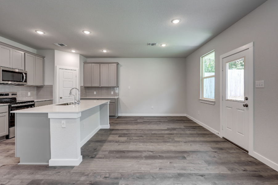 A kitchen with white cabinets.