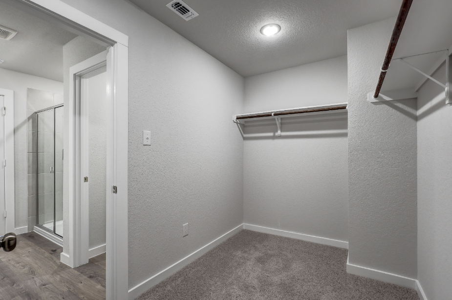 A room with a shower and a door.