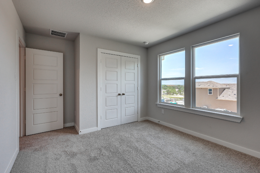 A room with white doors and a window.