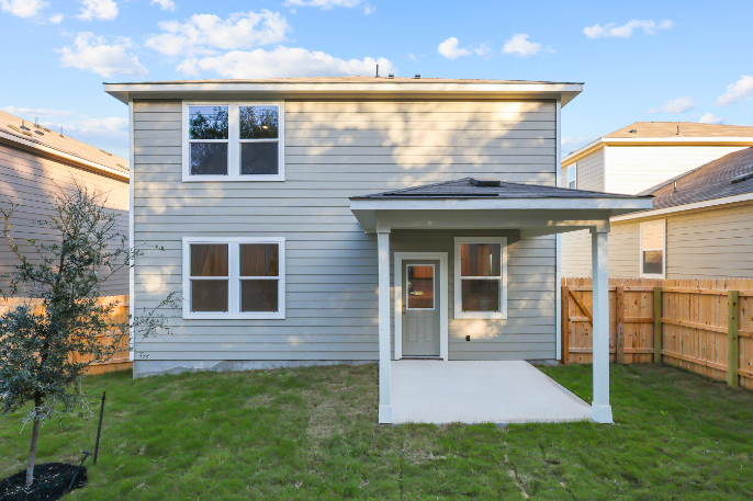 A house with a fence and grass.