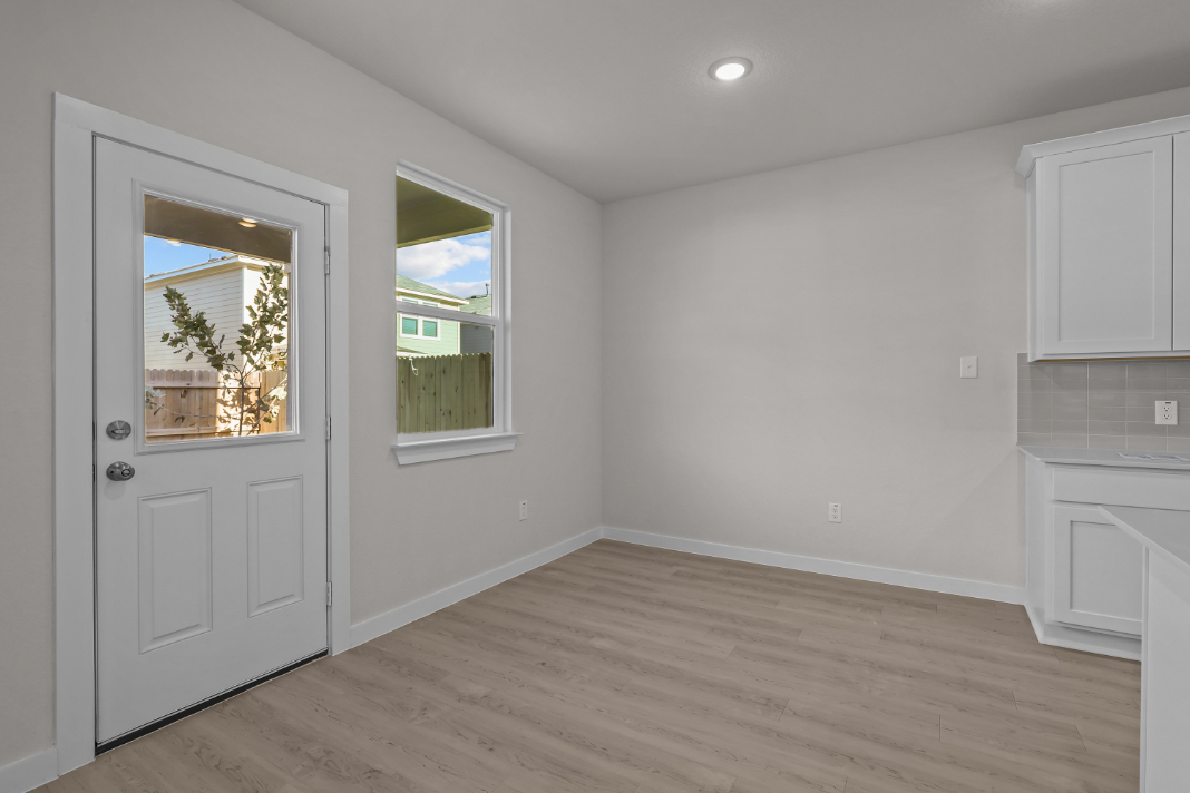 A room with white walls and a wood floor.
