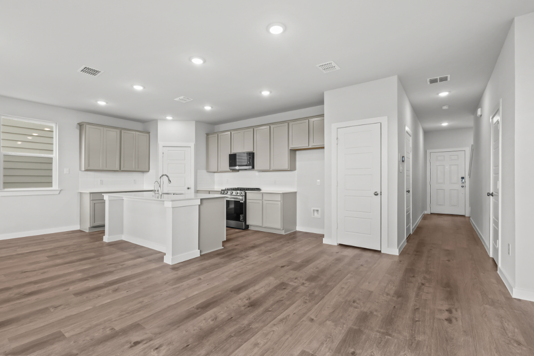A kitchen with white cabinets.