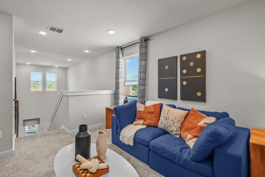 A living room with a blue couch.