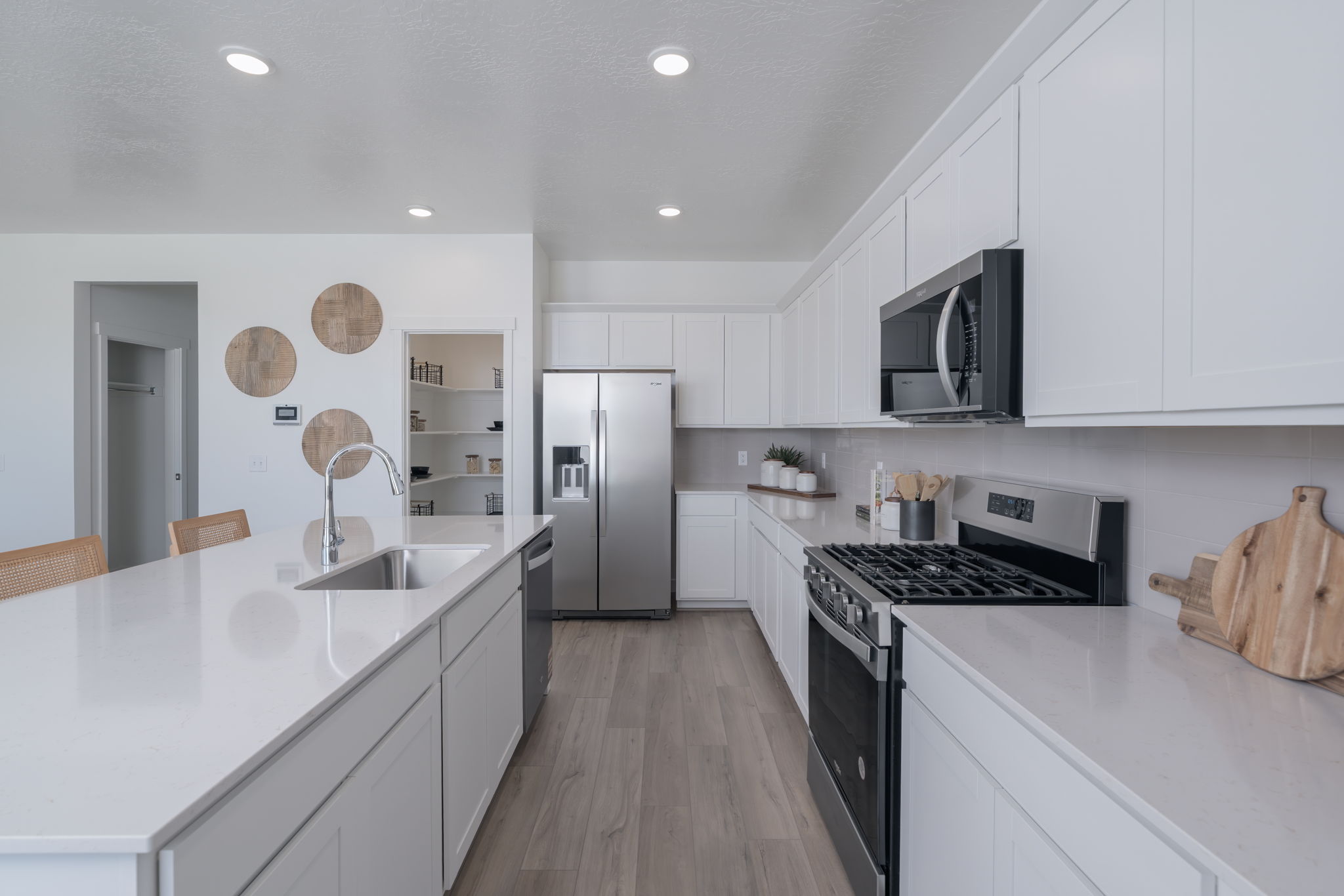 A kitchen with white cabinets.