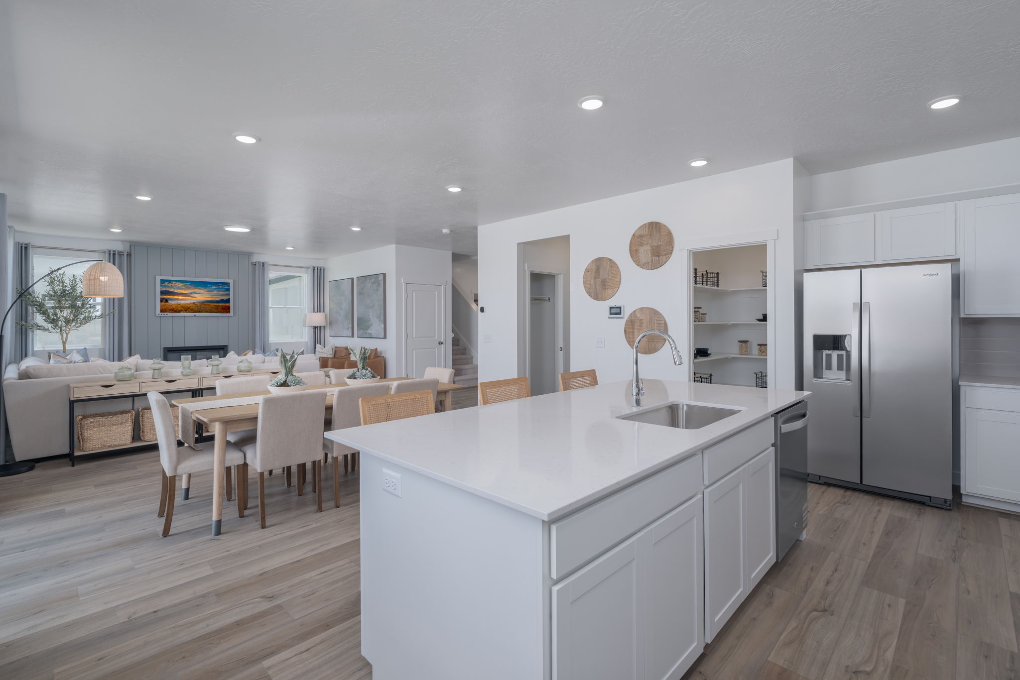A kitchen with white cabinets.