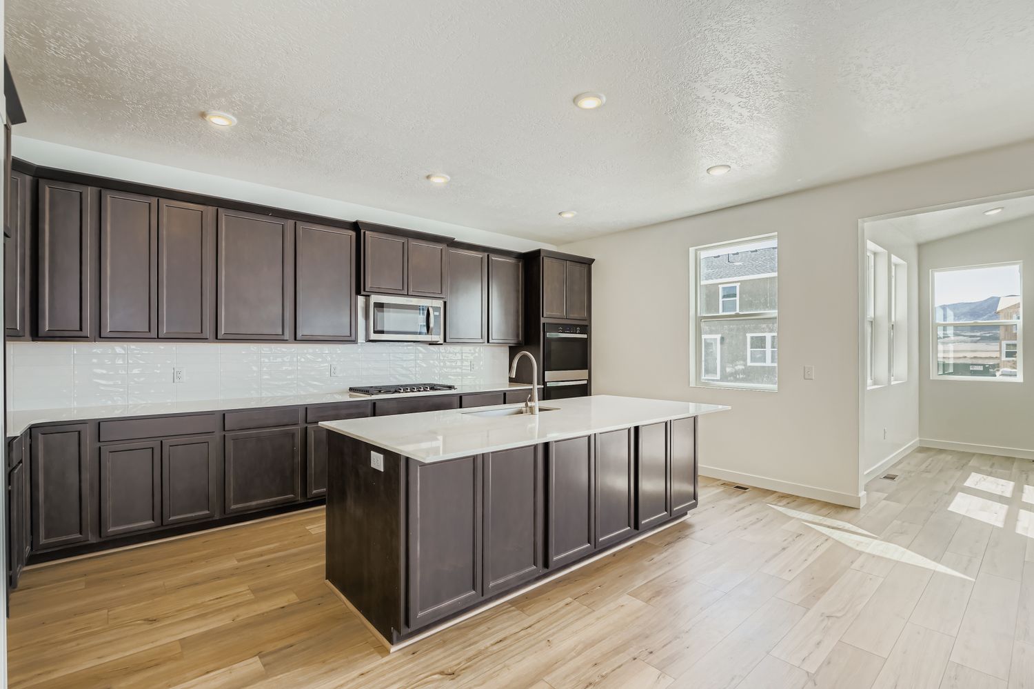 A kitchen with black cabinets.