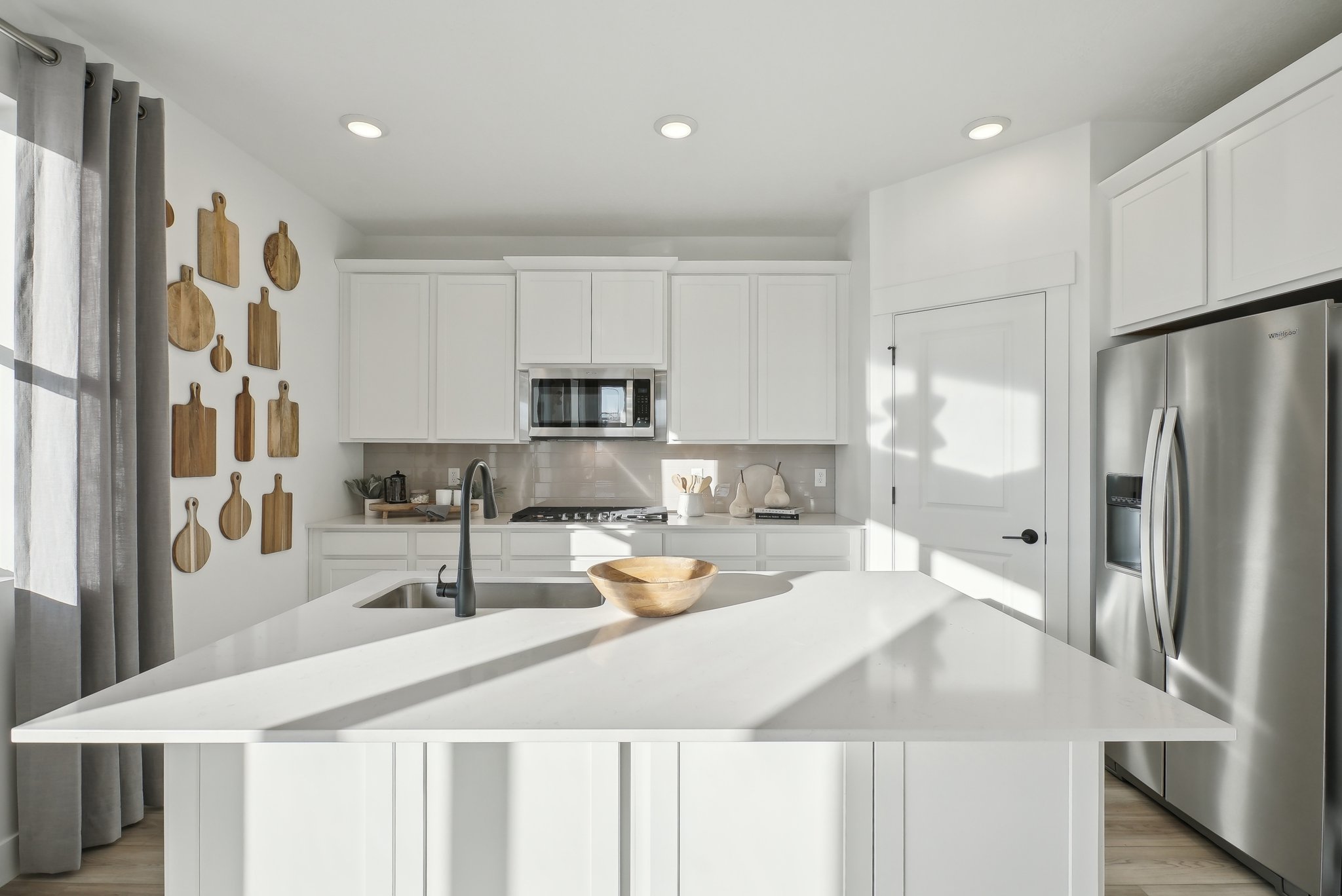 A kitchen with white cabinets.