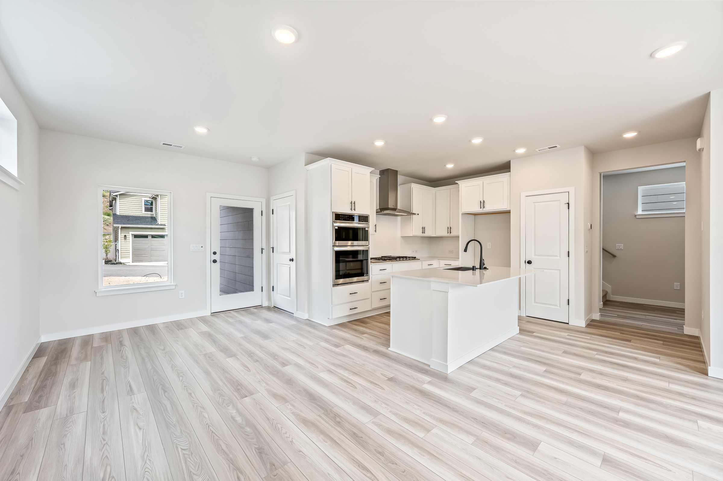 A kitchen with white cabinets.