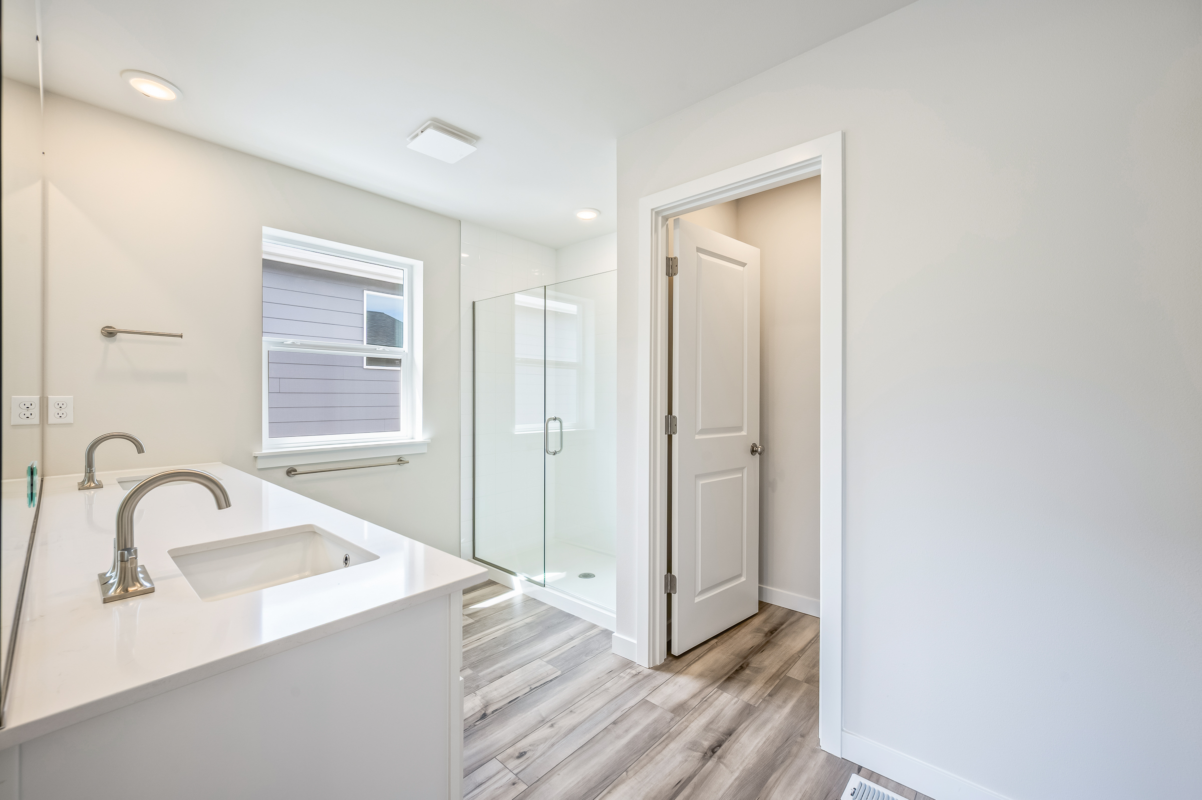 A bathroom with a sink and a shower.