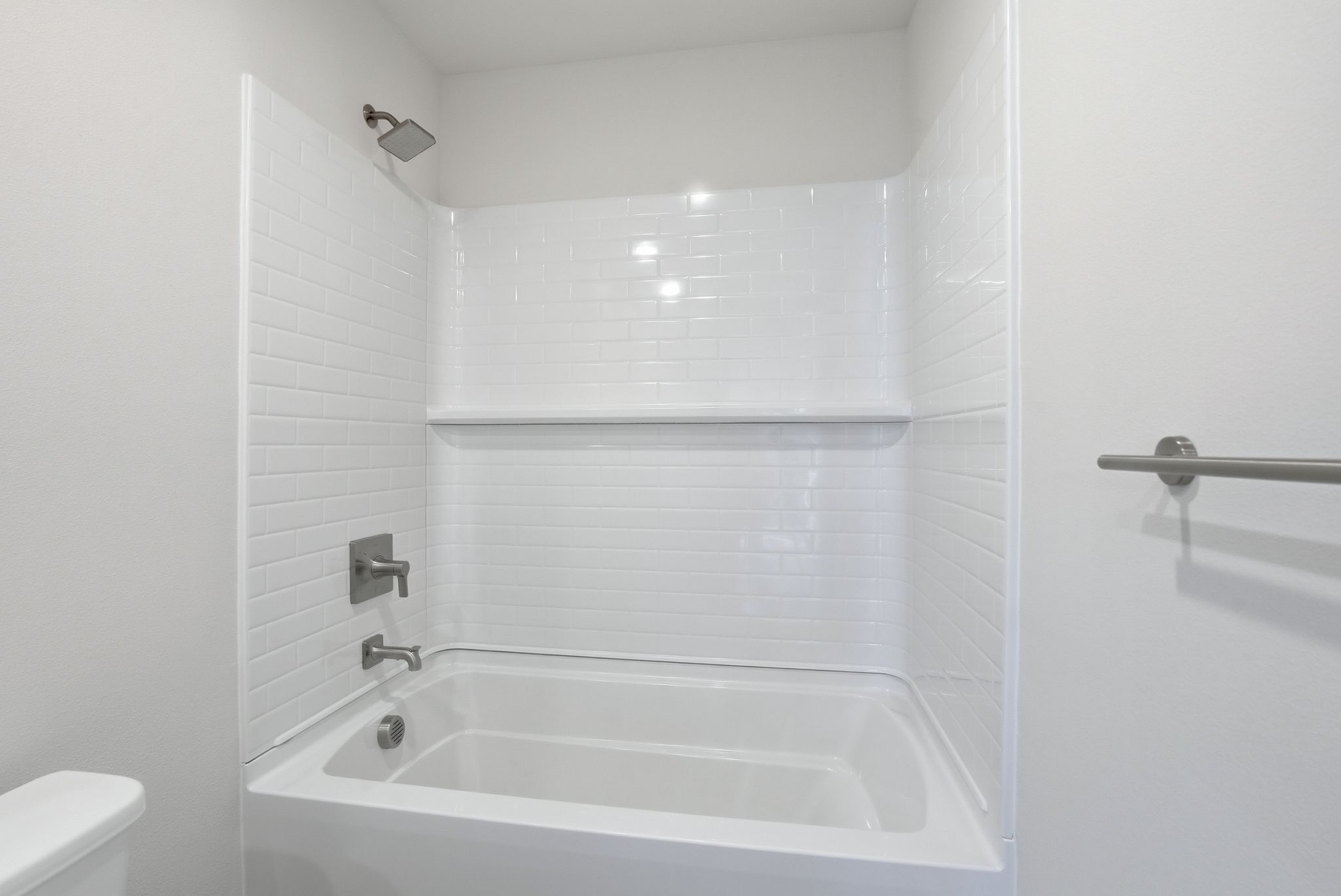 A white bathroom with a tub.