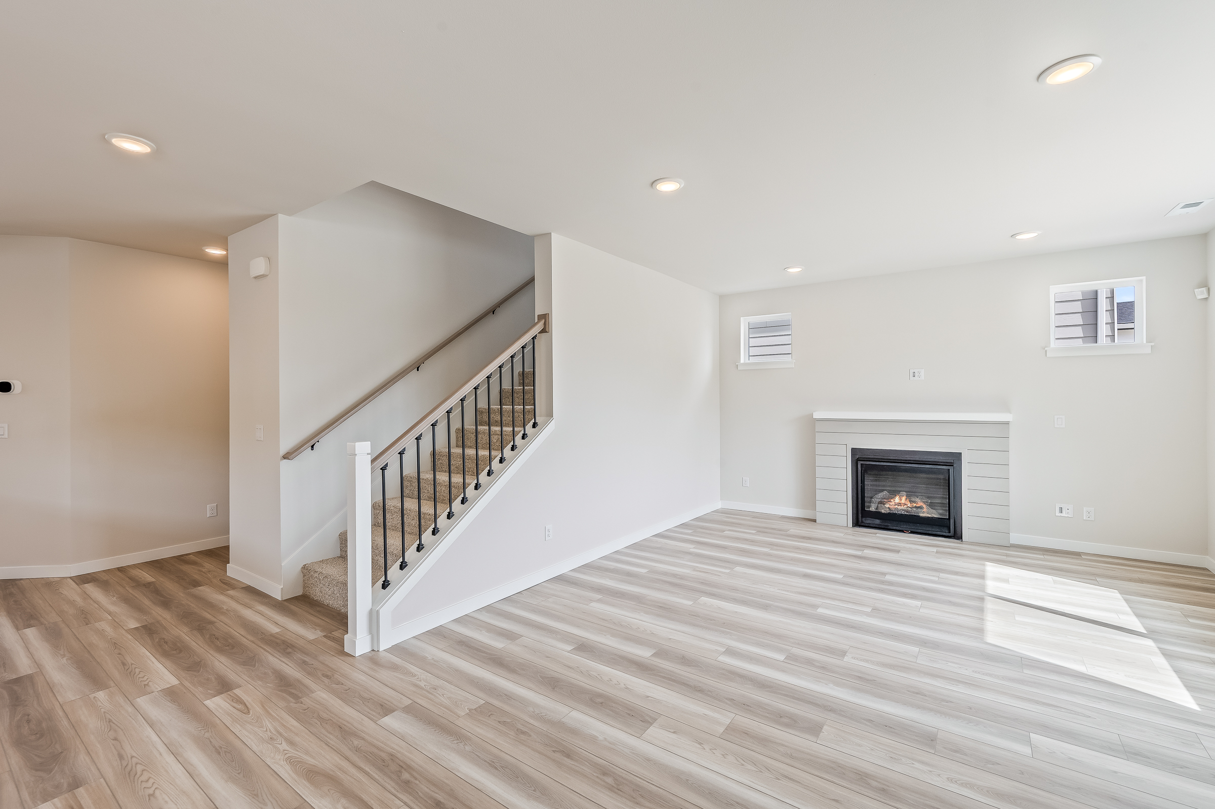 A room with a fireplace and a wood floor.