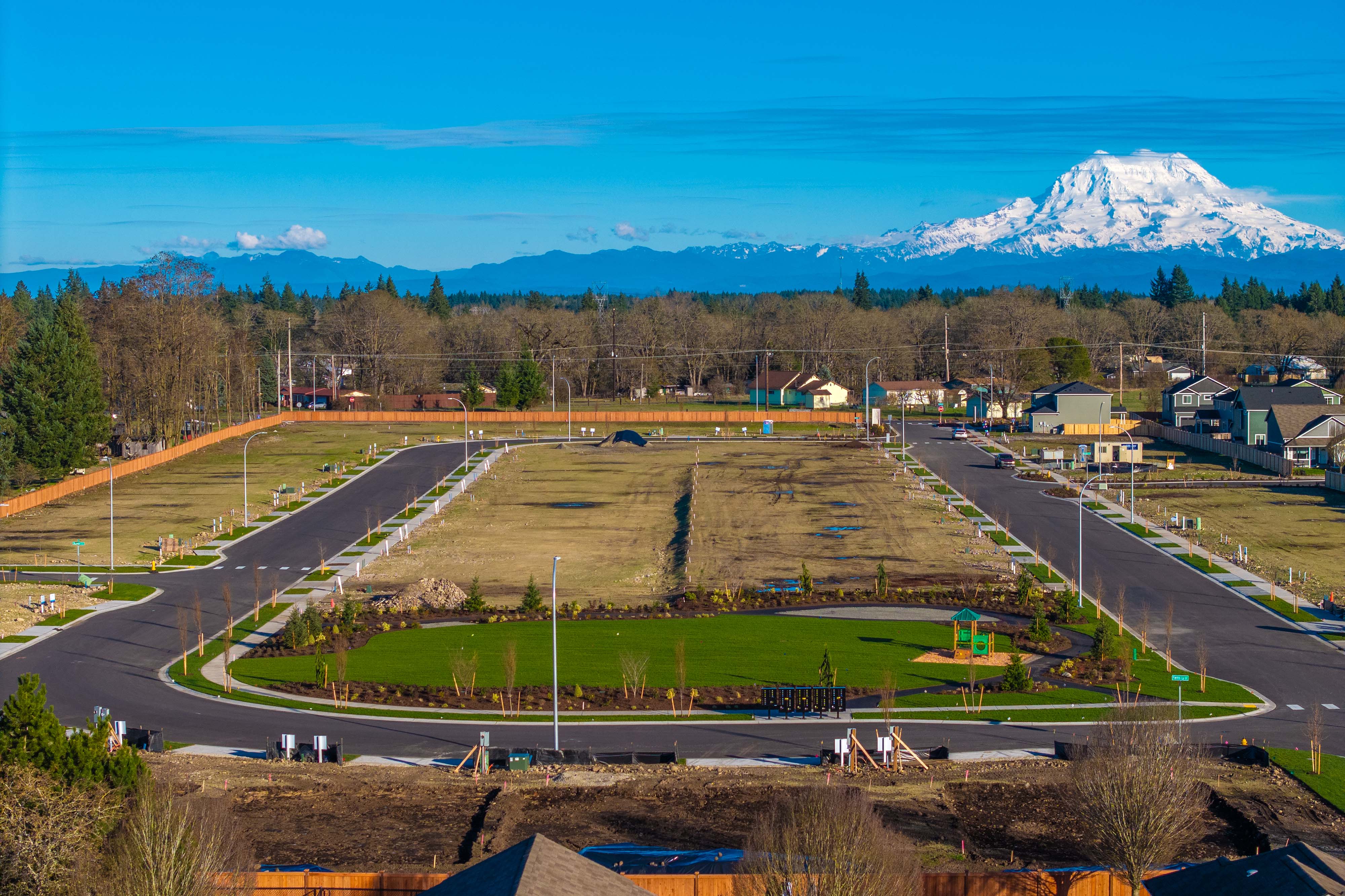 A landscape with a road and a mountain in the background.