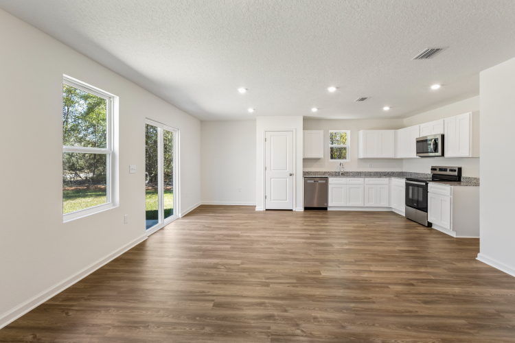 A large kitchen with white cabinets.