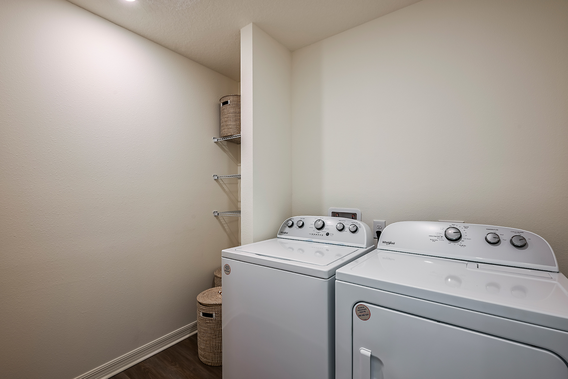 A kitchen with a washer and dryer.