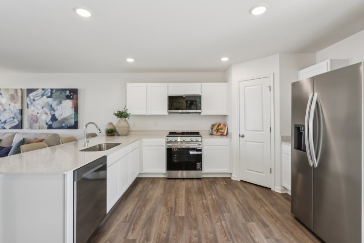 A kitchen with white cabinets.