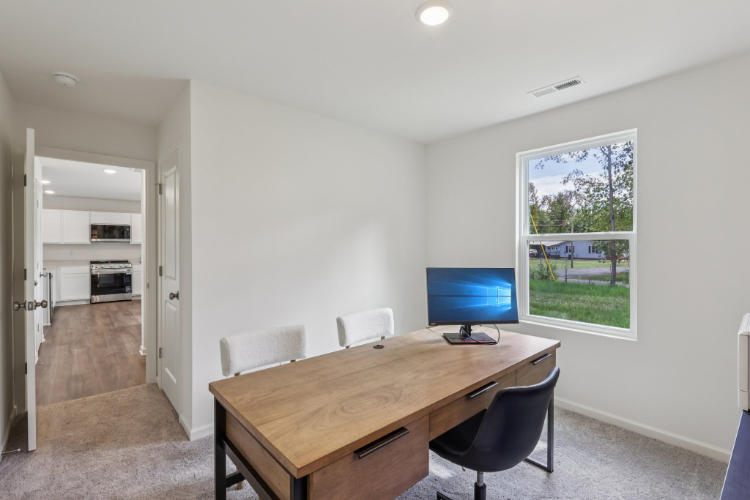 A room with a table and chairs.