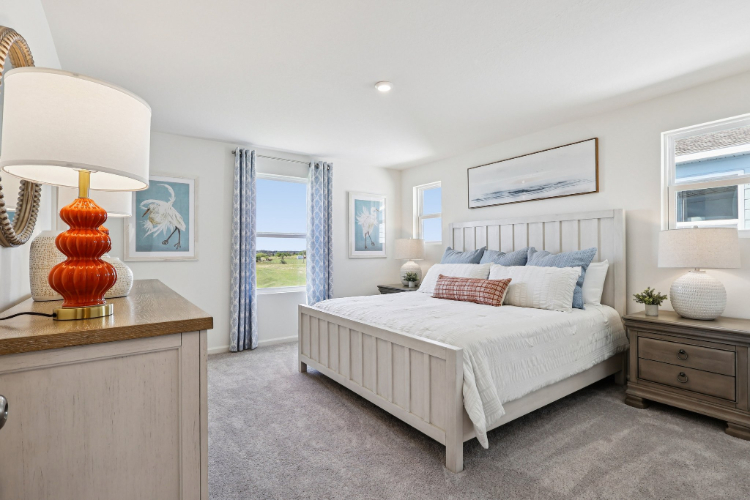 A bedroom with a bed and a lamp.