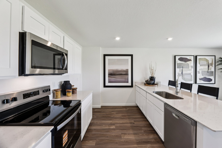 A kitchen with white cabinets.