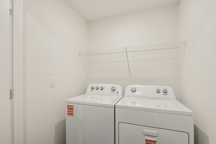 A washing machine in a room.