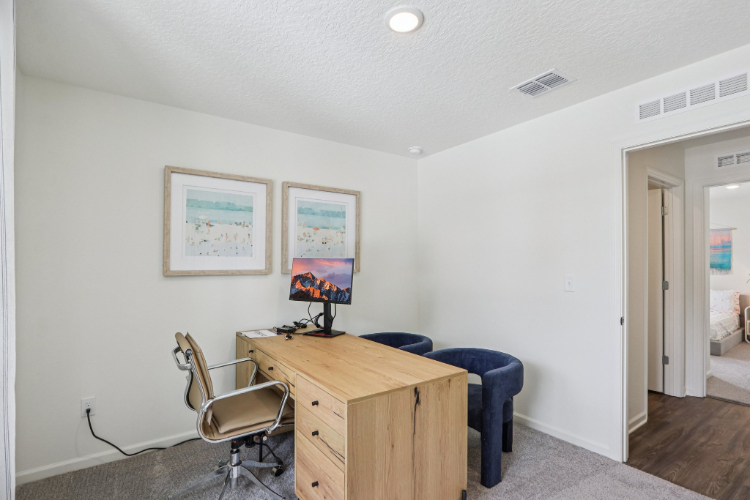 A room with a desk and a chair.