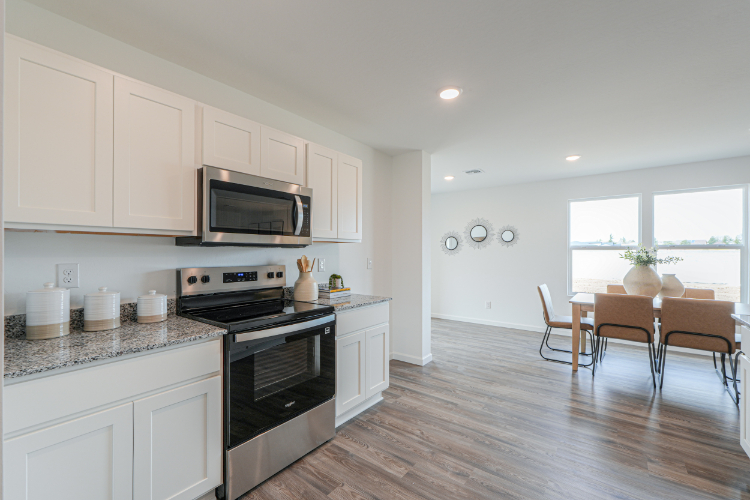 A kitchen with white cabinets.