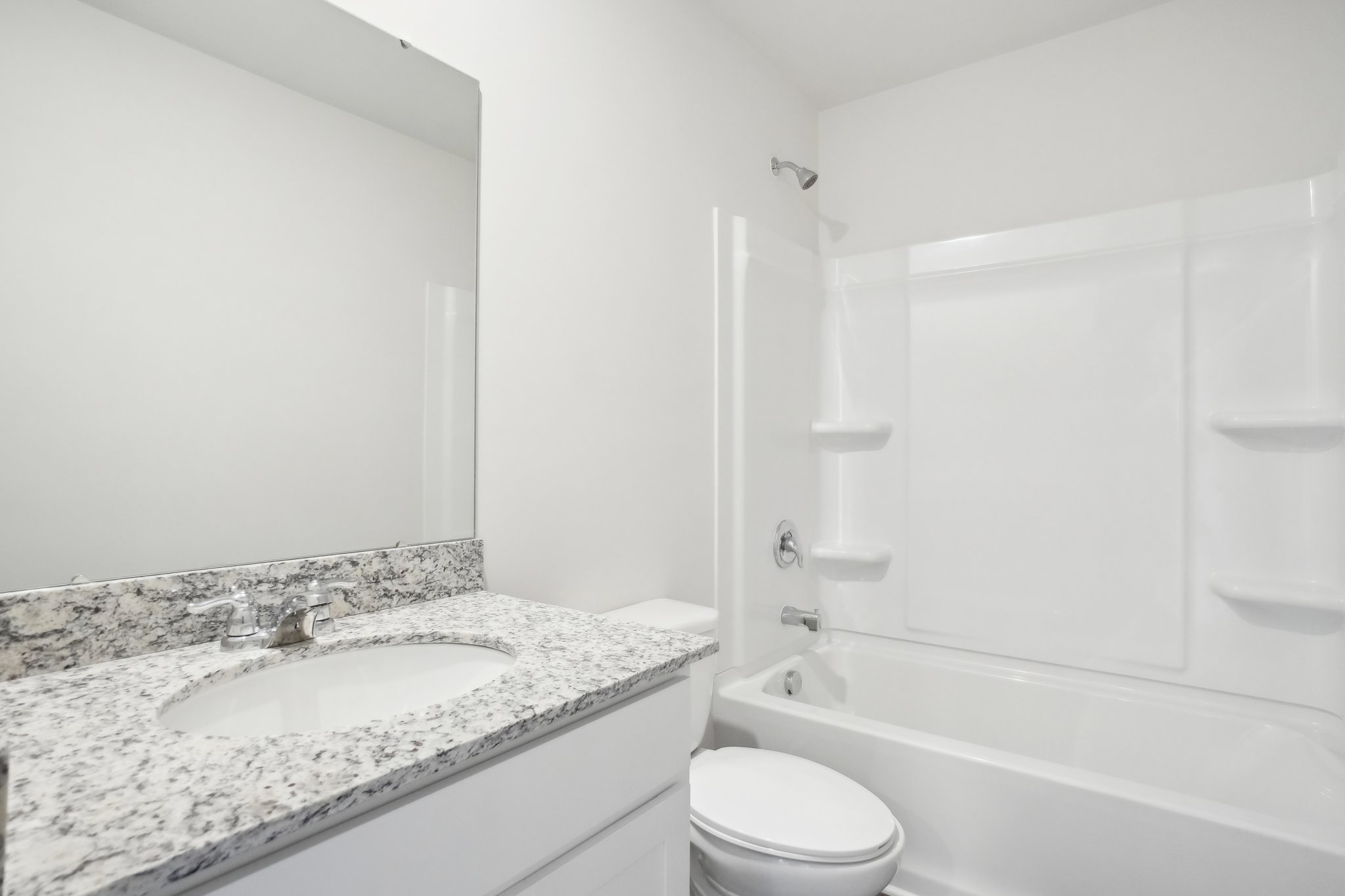 A bathroom with a marble countertop.