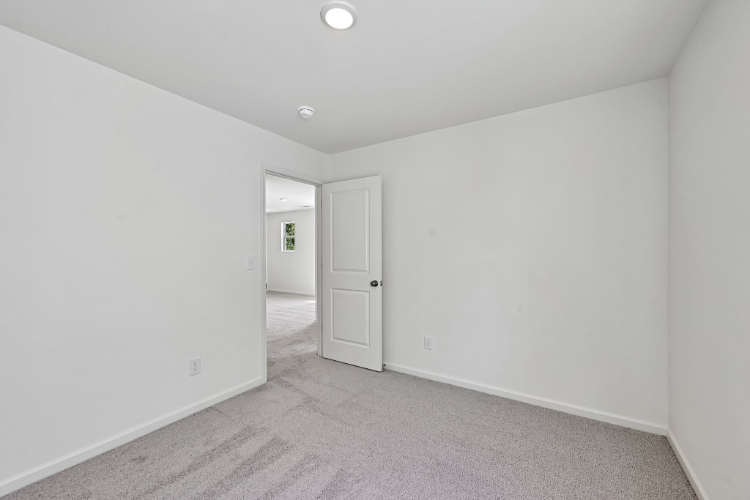 A hallway with white walls.
