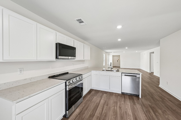 A kitchen with white cabinets.