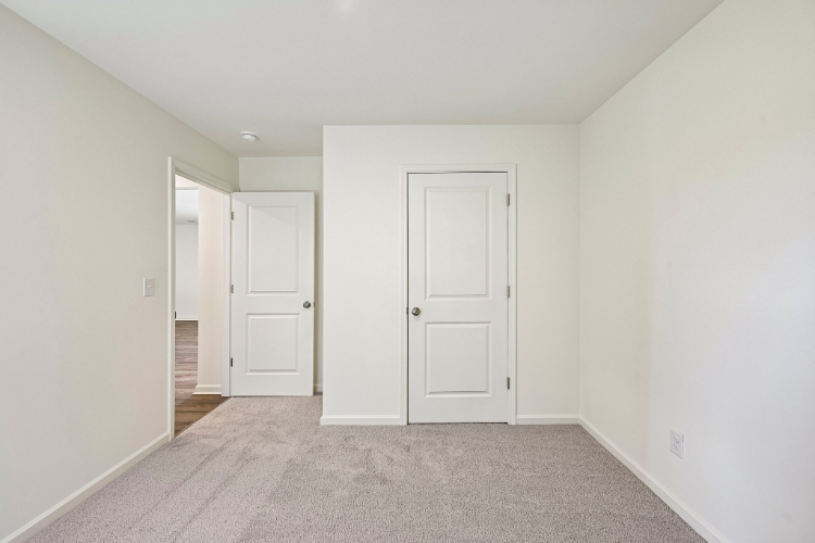 A hallway with white doors.