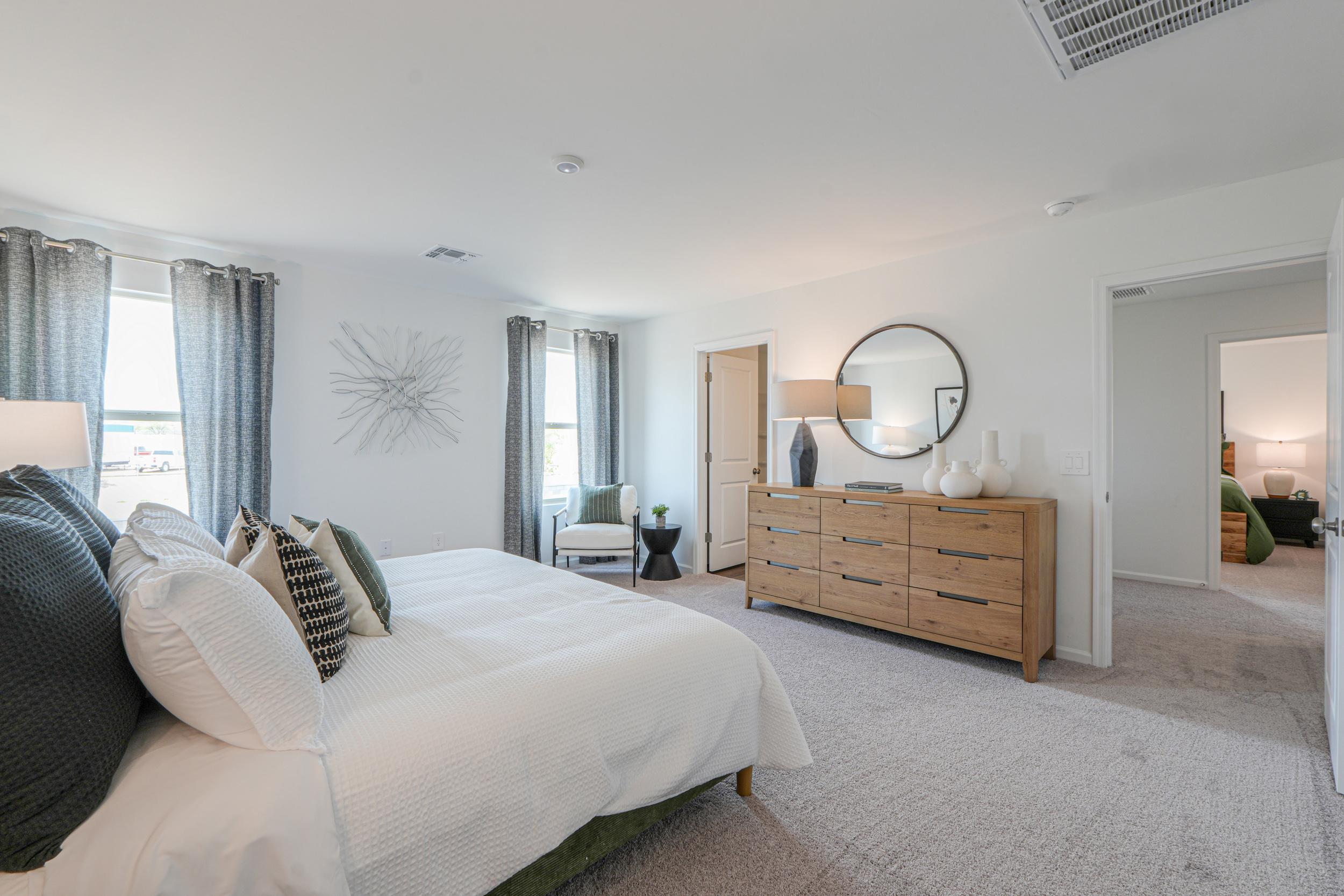 A living room with a couch and a dresser.