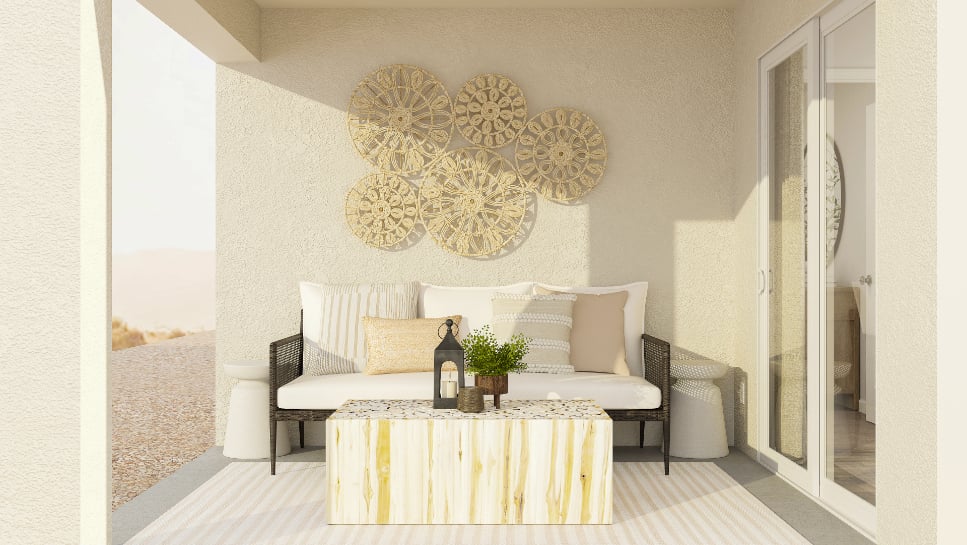 A room with a couch and a table with a bottle of wine.