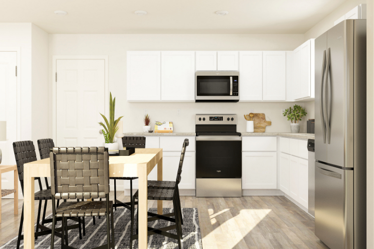 A kitchen with white cabinets.