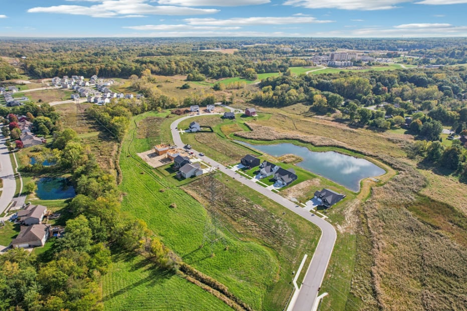 A landscape with a river and houses.