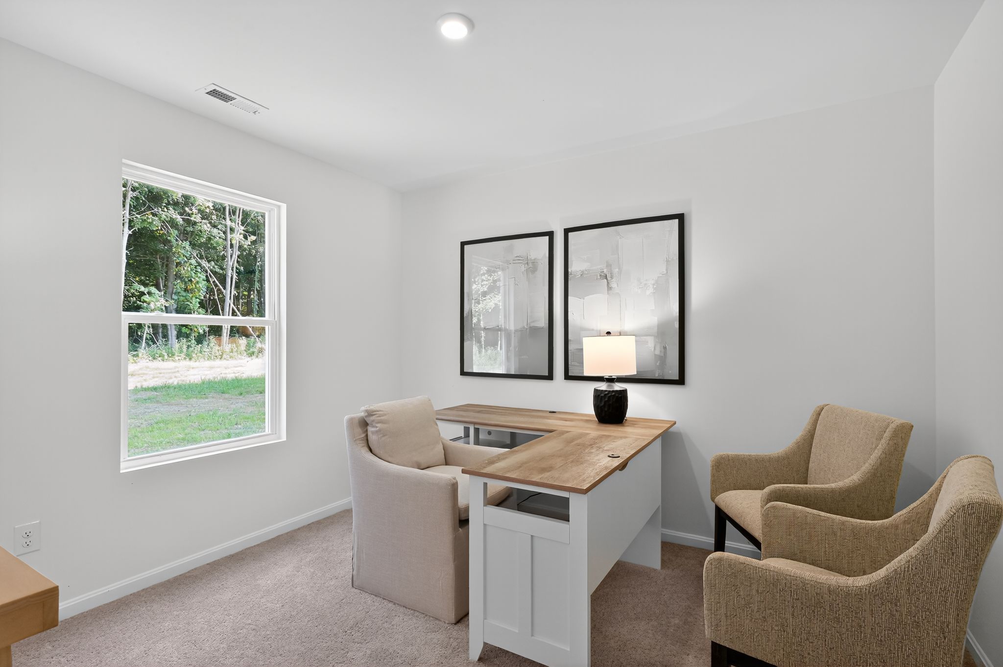 A room with a desk and chairs.