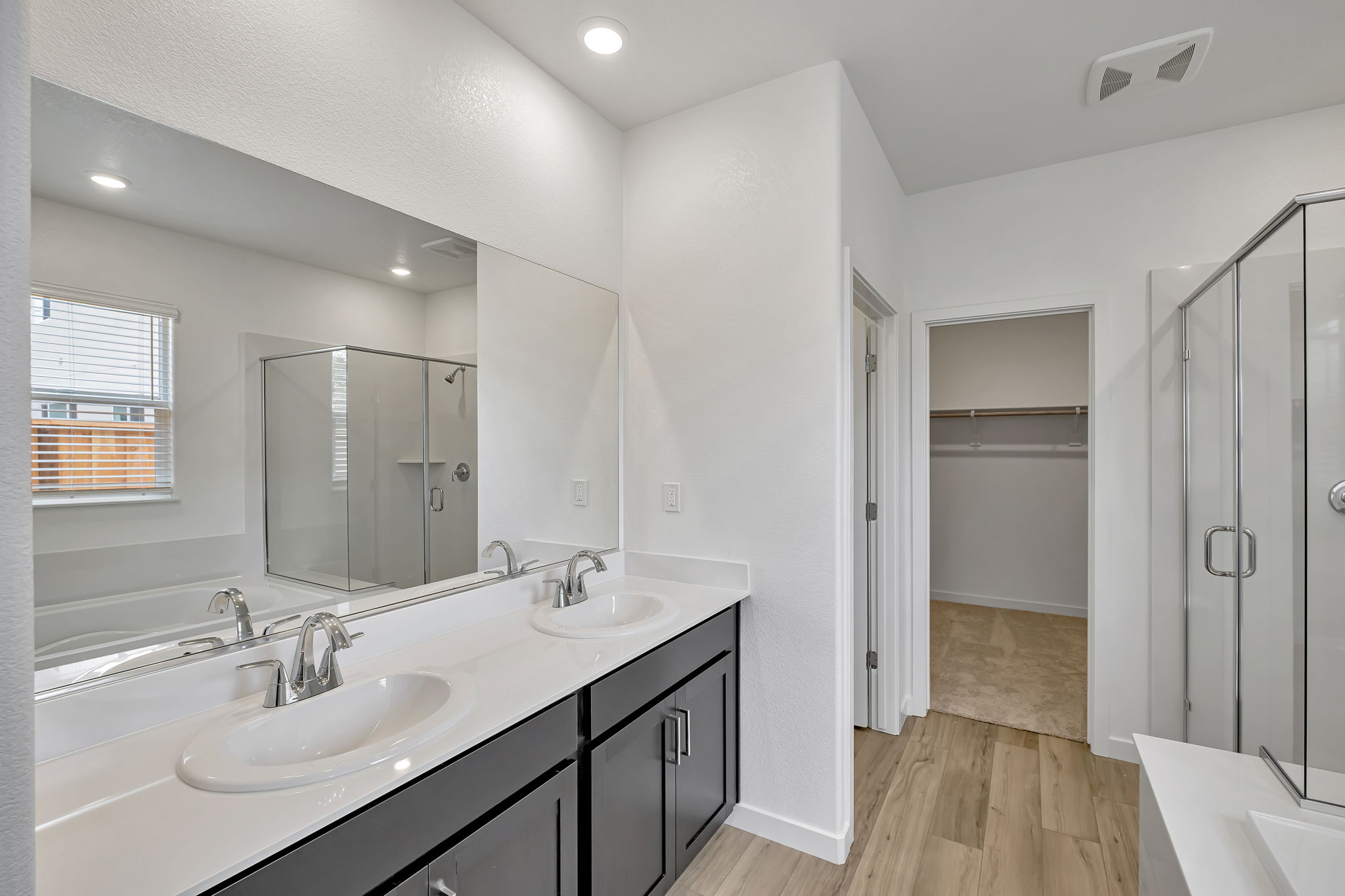 A bathroom with a large mirror.