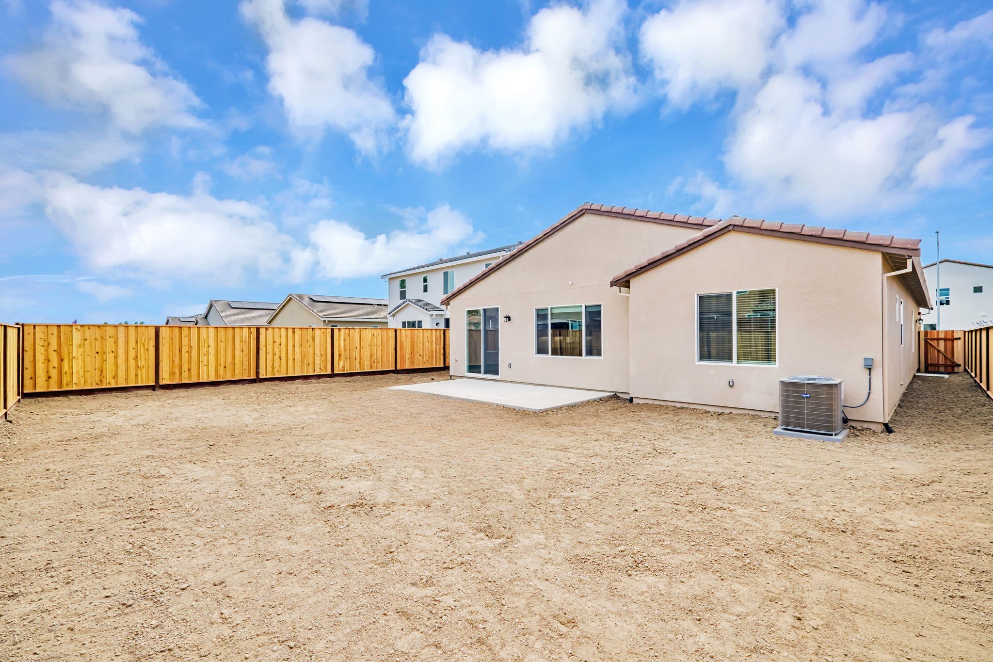 A house with a dirt yard.