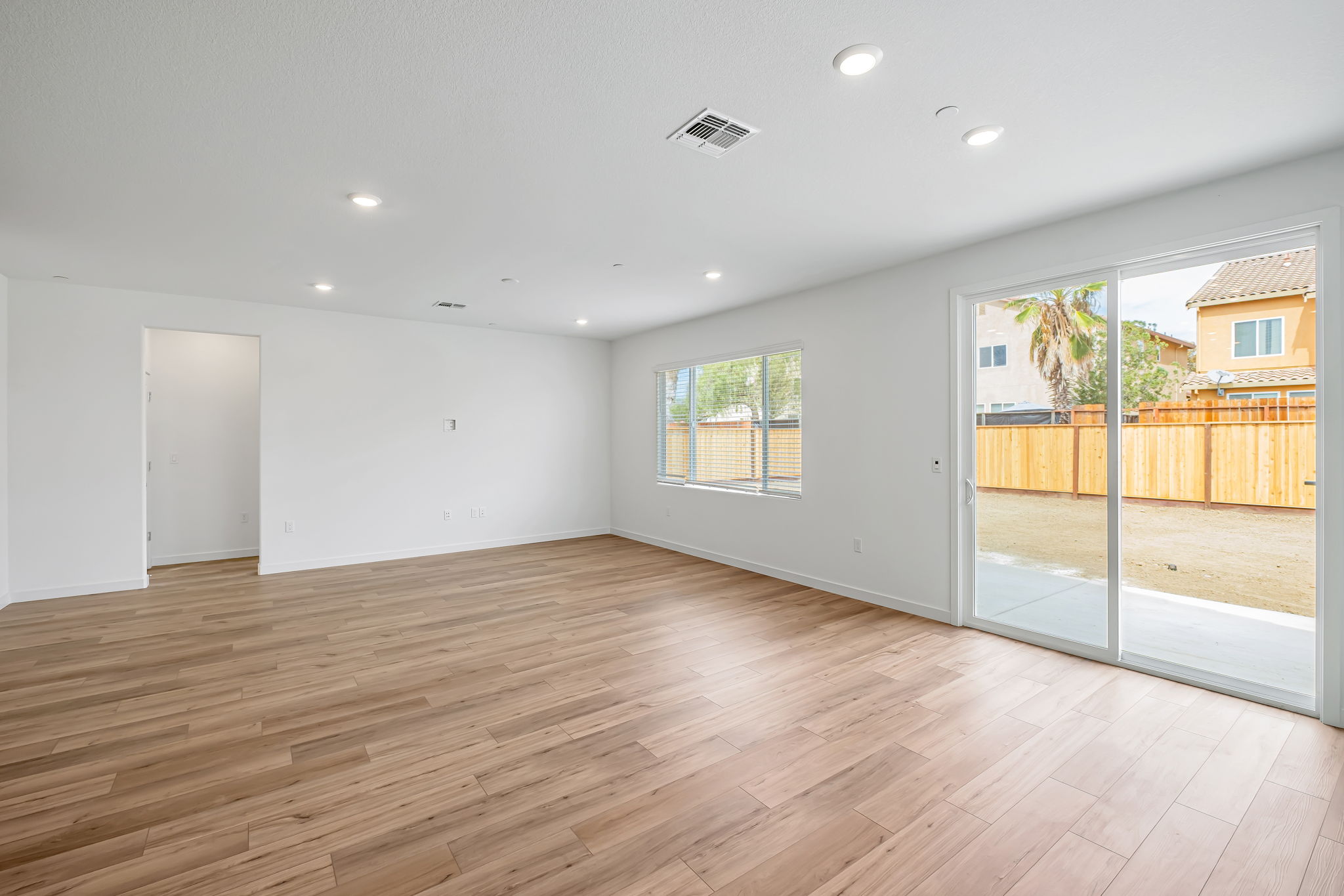 A room with a wood floor and a wood floor with a wood railing.