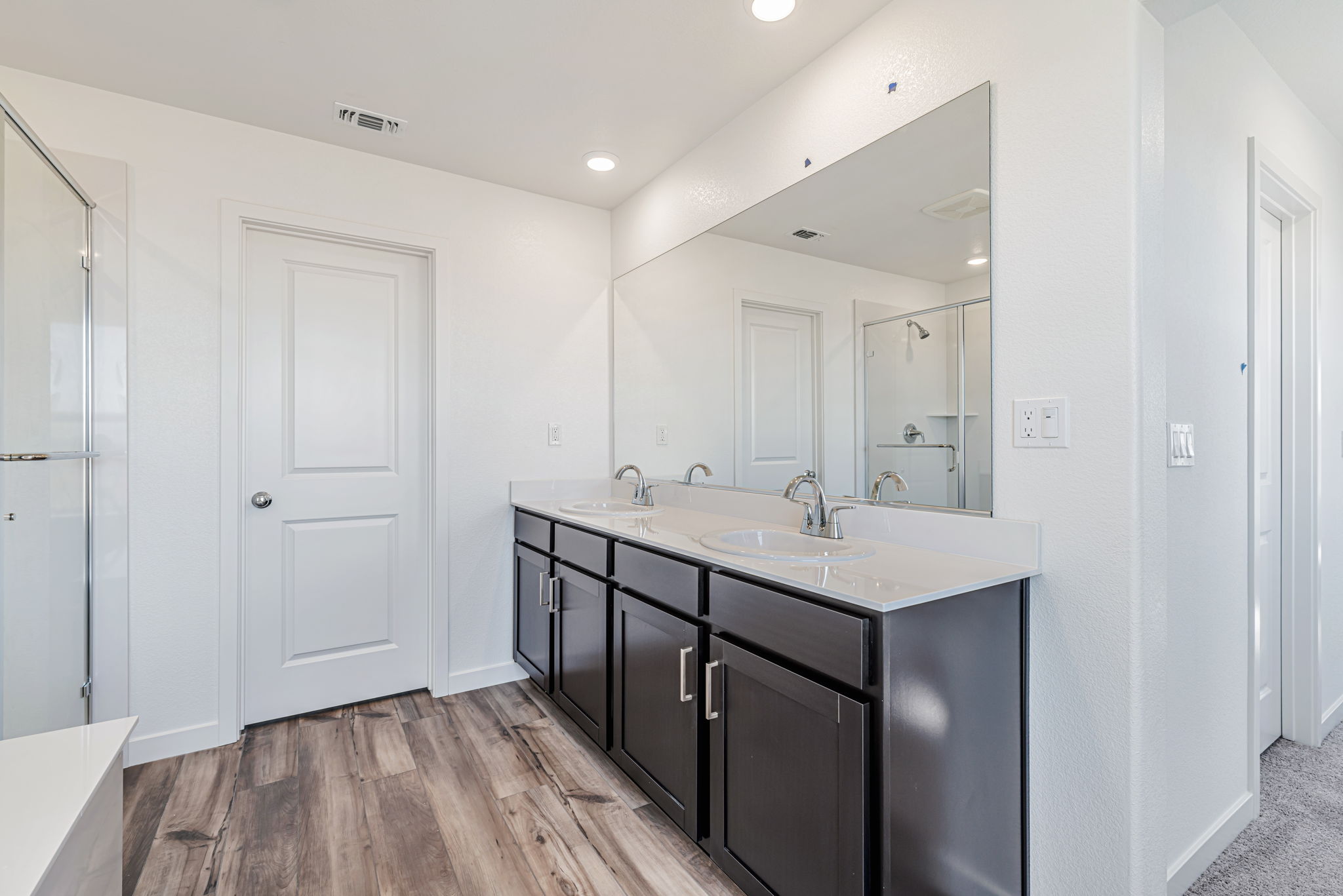 A bathroom with a large mirror.